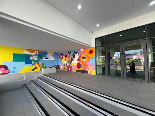 an empty bowling alley with a colorful wall at Star Hotel Chiang Mai - SHA Extra Pus in Chiang Mai