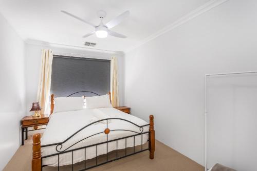 a bedroom with a bed and a window at Singleton Impressions - EXECUTIVE ESCAPES in Singleton