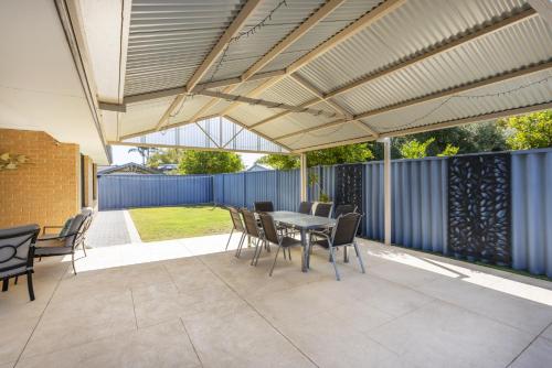 a patio with a table and chairs under awning at Singleton Impressions - EXECUTIVE ESCAPES in Singleton