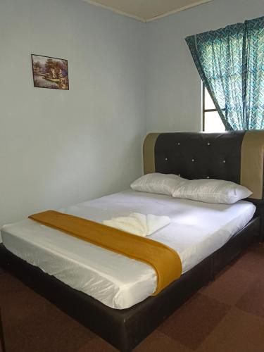 Postel nebo postele na pokoji v ubytování Mountain House Pekan Nabalu