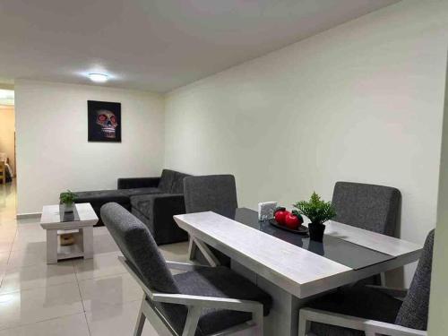 a room with a table and chairs and a couch at Apartamento cerca autódromo in Mexico City