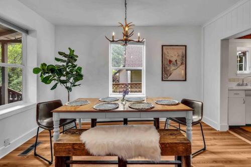 a dining room with a table and chairs at Where We Roam Log Cabin with Mountain Views in Kellogg