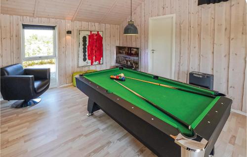 a billiard room with a pool table and a chair at Holiday Home Hyldemose Sydals Iii in Skovby