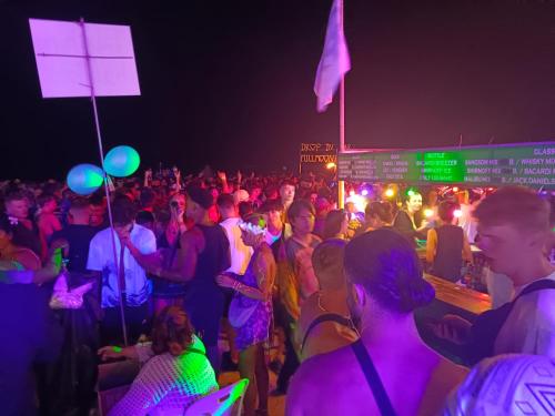 a crowd of people at a party at night at Haadrin village Fullmoon in Haad Rin