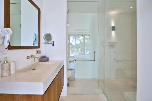 a bathroom with a glass shower and a sink at Pagi Villas by Betterplace in Canggu