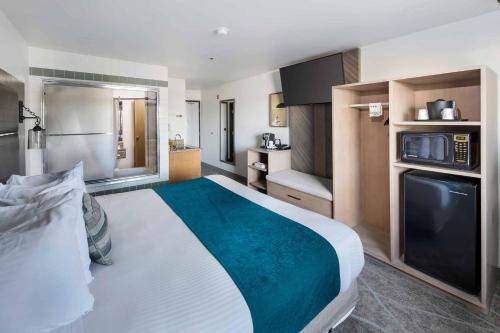 a hotel room with a large bed and a kitchen at The Marina Inn in Anacortes
