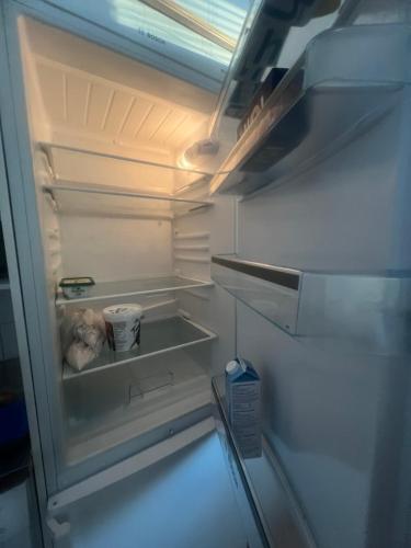 een lege koelkast met open deur bij Whole Apartment in Vantaa