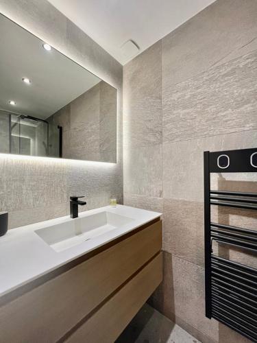 a bathroom with a white sink and a mirror at Sea and mountain views from your Rooftop ! in Saint-Laurent-du-Var