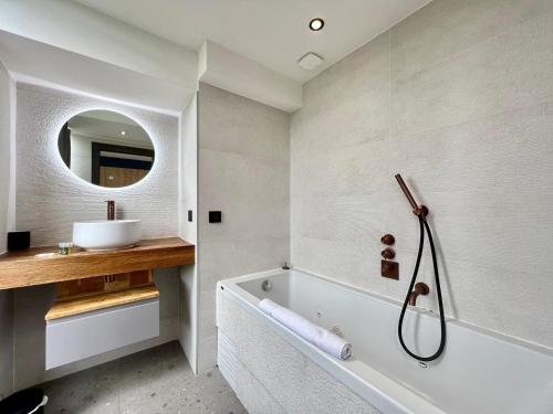 a bathroom with a tub and a sink and a mirror at Sea and mountain views from your Rooftop ! in Saint-Laurent-du-Var