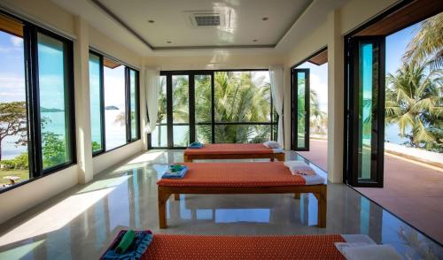 two beds in a room with a view of the ocean at KaiBaeBeach GrandView in Trat