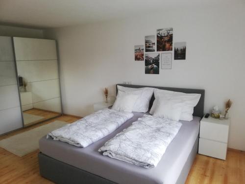 ein Bett mit zwei Kissen auf einem Zimmer in der Unterkunft Ferienwohnung Bergnest in Niederndorferberg