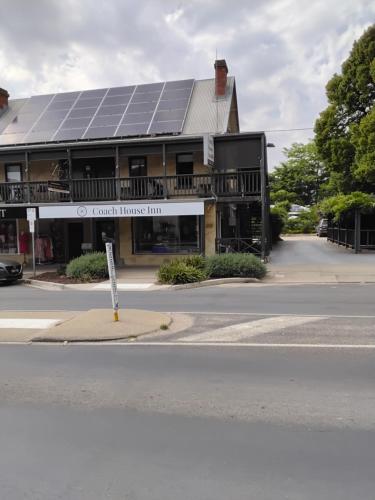 a building with a lot of solar panels on the roof at Coach House Inn in Bright