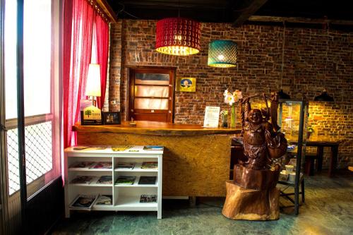 a room with a counter and a shelf with shoes at Fong Chou Chalet in Sanyi