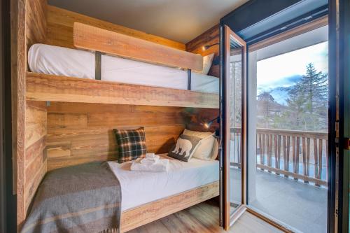 a bedroom with two bunk beds and a balcony at Simona LuxuryApartment Few Steps From Ski - Happy Rentals in Sestriere