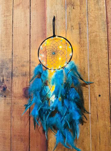 a blue feather chandelier hanging on a wooden wall at Blue House in Puerto Escondido