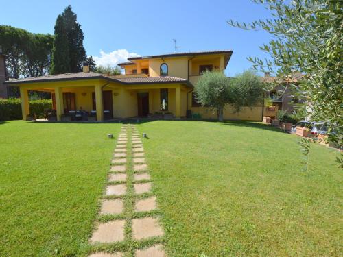 una casa con un camino de ladrillo delante de un patio en Pretty villa in Marsciano with nice garden and private pool, en Marsciano