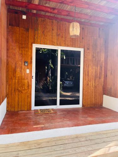 a large window in a room with wooden walls at Blue House in Puerto Escondido