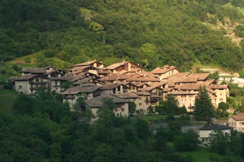 a group of houses on the side of a mountain at Casa del Vasaio in Tenno