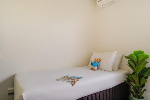 a stuffed teddy bear sitting on top of a bed at Mercure Albury in Albury