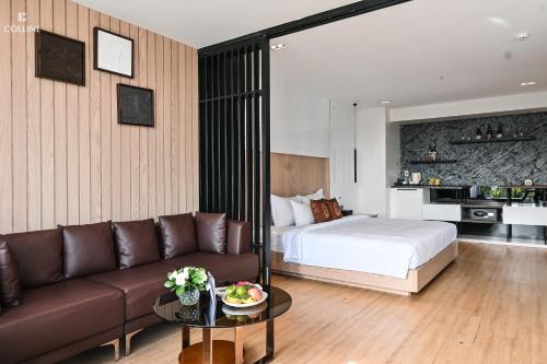 a hotel room with a bed and a couch at Colline Dalat in Da Lat