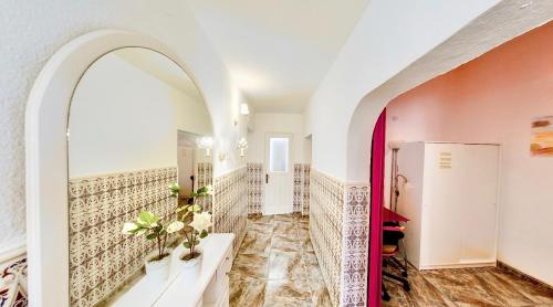 a hallway with an archway and a tile wall at Casa Dominica in La Guancha