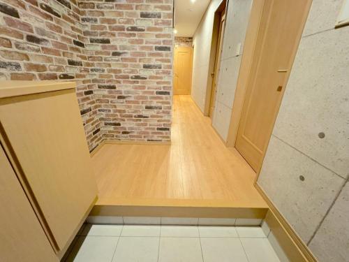 an empty corridor with a brick wall and a brick hallway at グランディオーソ沖縄ヴィラ恩納1 in Onna