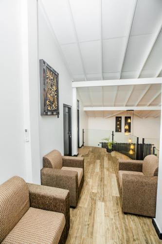 a waiting room with couches and chairs in a building at The Castle By Scenic Weligama in Weligama