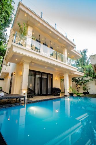 a large swimming pool in front of a house at The Castle By Scenic Weligama in Weligama