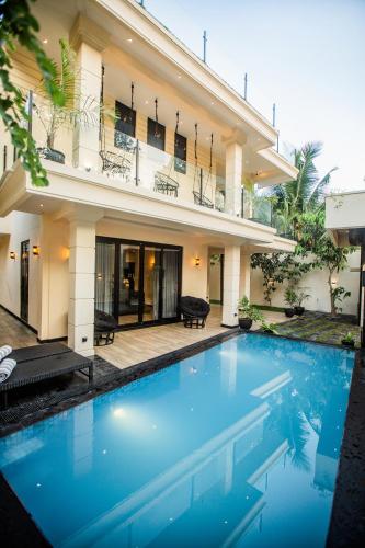a swimming pool in front of a house at The Castle By Scenic Weligama in Weligama