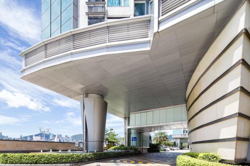 a building with a balcony on the side of it at Kowloon Harbourfront Hotel in Hong Kong