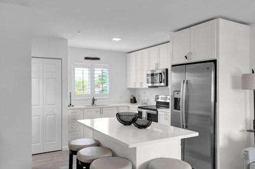 a kitchen with white cabinets and a white counter top at Keys Wade NEW 1B 2Bath in Marathon