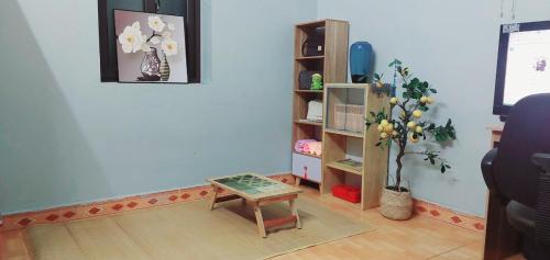 a living room with a table and a book shelf at LeMin Homestay in Hai Phong