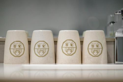 a row of four toilet paper rolls on a shelf at Taitung Spring Homestay B&B in Taitung City