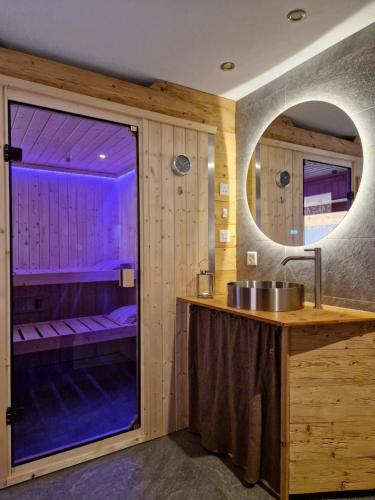 a bathroom with a sink and a large window at Chalet Diognysos B&B in Crans-Montana