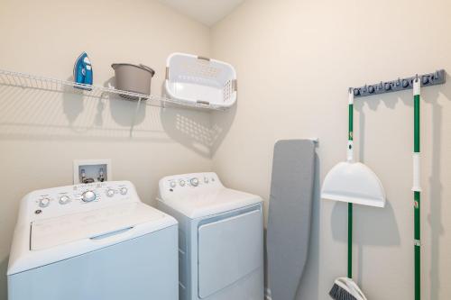 a laundry room with a washer and dryer at Top Villas - Championsgate 1713 in Kissimmee