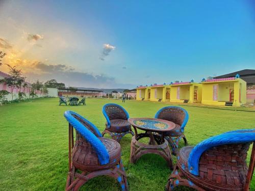a group of chairs and a table in a field at The Kukas Resort in Jaipur