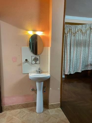 baño con lavabo y espejo en la pared en Fully furnished 1bhk flat near dhumbarahi area en Katmandú