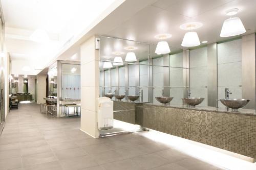a bathroom with a row of sinks and mirrors at Kowloon Harbourfront Hotel in Hong Kong