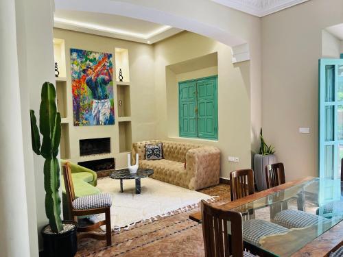 a living room with a couch and a table at Charming Villa with Pool, Garden and Pingpong in Marrakech