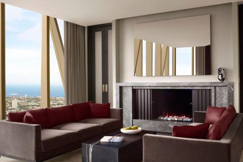 a living room with a couch and a fireplace at The Ritz-Carlton, Melbourne in Melbourne