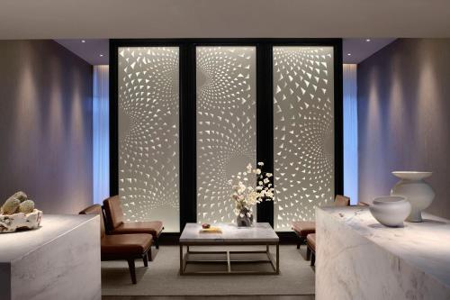 a lobby with a large window with lights on it at The Ritz-Carlton, Melbourne in Melbourne