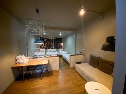 a living room with a couch and a table at Yaksa Private in Bangkok