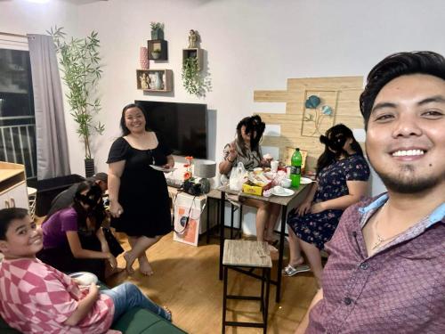 a group of people sitting in a living room at 1 - Bedroom Garden @ Messatierra Garden Residences in Davao City