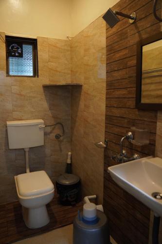 a bathroom with a toilet and a sink at Redstone House by Oxystays Hospitality in Ganpatipule