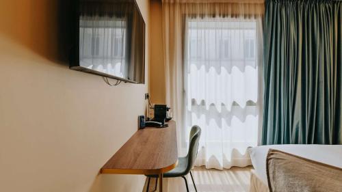 a room with a wooden table in front of a window at Keystone Hôtel & Spa in Lyon