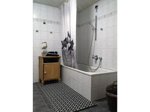a bathroom with a shower and a bath tub at Holiday apartment Rüf Stefanie 