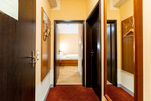 a hallway with a door leading to a bathroom at Hotel Alter Kranen in Würzburg