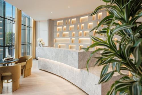 a lobby of a hotel with a potted plant at Jumeirah Living World Trade Centre Dubai in Dubai