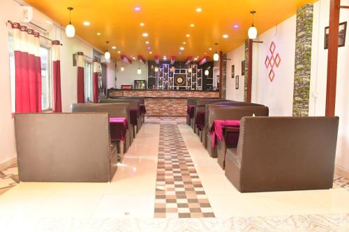 a row of chairs in a restaurant with a checkered floor at Hotel Jiyan Hospitality Pvt. Ltd. in Dhangadhi