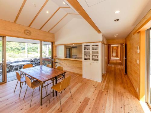 a kitchen and dining room with a table and chairs at guesthouse Amami Long Beach2 in Koshuku